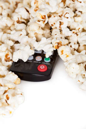Close-up Of Remote Control And Popcorn Over White Backgroundの写真素材
