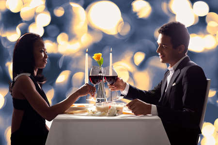 Portrait Of Romantic Couple Toasting Red Wine At Dinner