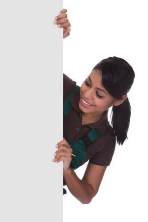 Young Female Gardner Holding Placard Over White Backgroundの写真素材
