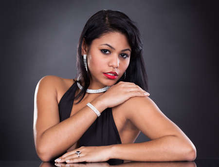 Young Beautiful Woman Wearing Diamond Jewelry Over Black Backgroundの写真素材