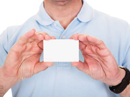 Man Holding Blank Visiting Card Over White Backgroundの写真素材