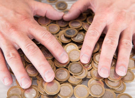 Close-up Of The Male Hand On Coins
