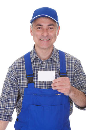Mature Male Technician Holding Visiting Card Over White Backgroundの写真素材