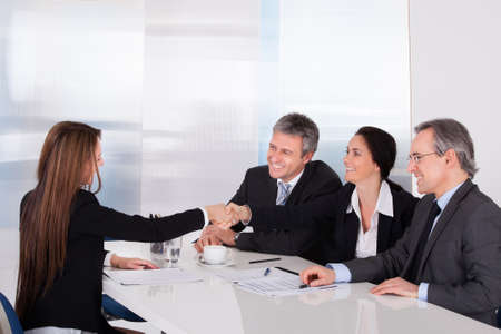 Businessmen Looking At Business Women Shaking Hand Businessmen Looking At Business Women Shaking Hand