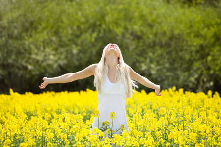 Smiling Relaxed Young Woman Amid With Flowers In Field