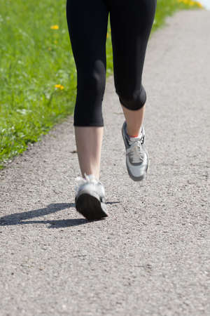 Portrait Of Young Healthy Woman Jogging In Parkの写真素材