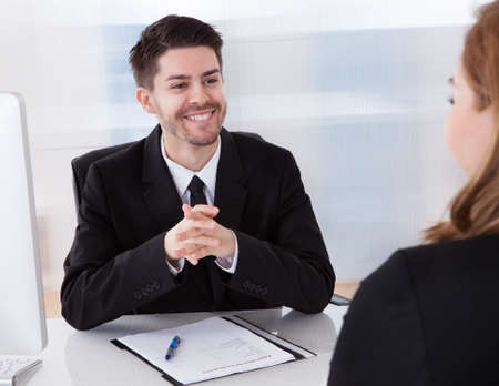 Two businesspeople talking with each other at office