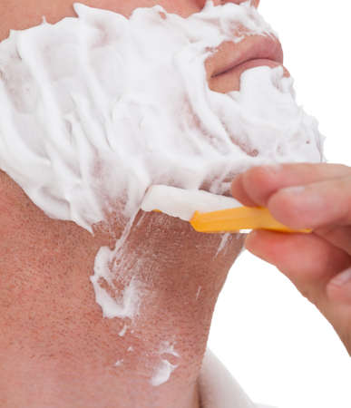 Close Up On A Young Man Shaving His Beard With A Razor