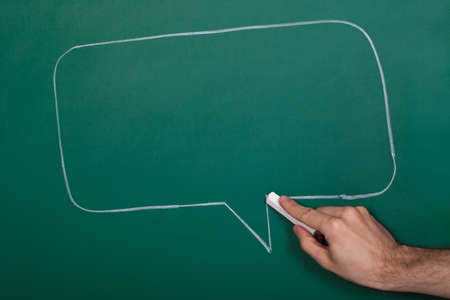 Hand Drawing Speech Bubble On Green Blackboardの写真素材