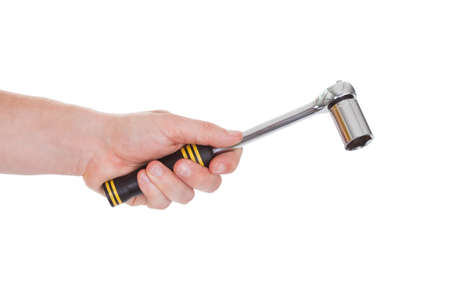 Close-up Of Hand Holding Ratchet Over White Background