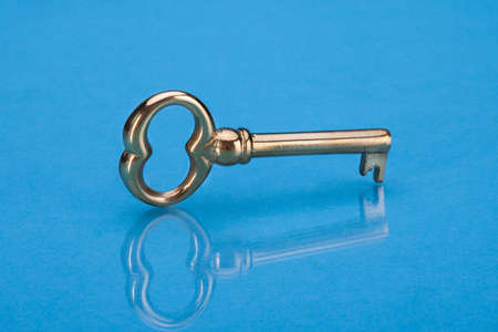 Photo Of Golden Key Isolated Over Blue Background
