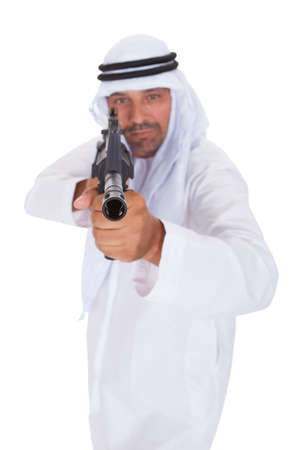 Happy Mature Islamic Man Holding Gun Over White Background