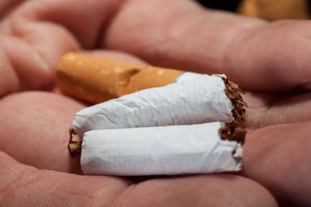 Close-up Shot Of Hand Holding Broken Cigarette