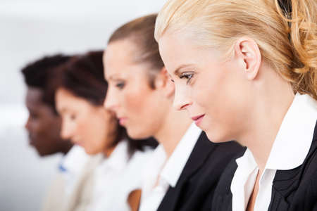 Portrait Of Happy Businesswoman Sitting With Her Colleaguesの写真素材
