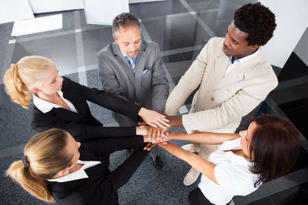 High Angle View Of Multiracial Businesspeople Stacking Hands Over Each Other