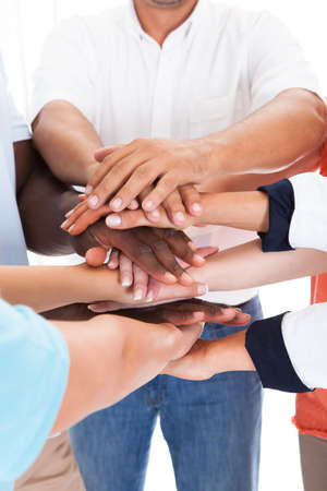 Close-up Of Hand Lying On Top Of Each Other Over White Background