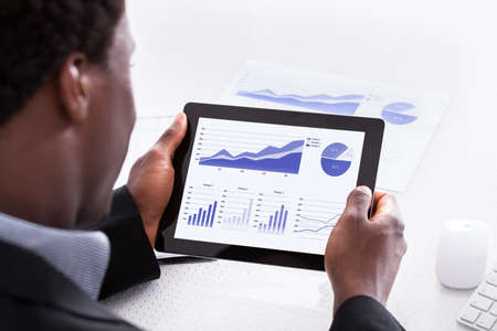 Close-up Of Businessman Looking At Digital Tabletの写真素材