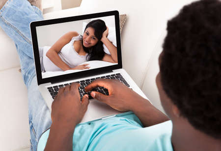 Man And Woman Communicate Through Video Chat On Modern Electronic Digital Tabletの写真素材