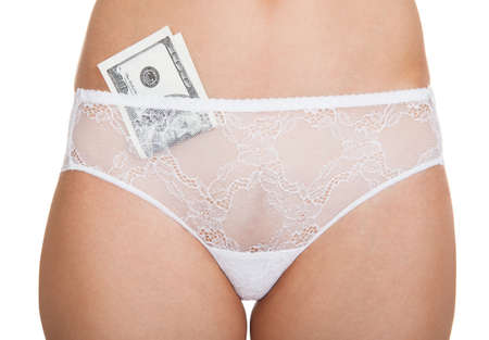 Close-up of a woman wearing lingerie with banknotes in pantiesの写真素材