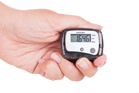 Close-up Of Hand  Holding Digital Pedometer On White Backgroundの写真素材