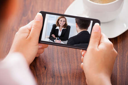 Close-up Of Woman Looking At Video Conference On Mobile Phone