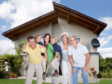 Portrait of happy generations family In Front Of House