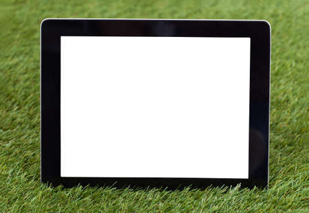 Close-up Of Blank Digital Tablet On Green Grassの写真素材