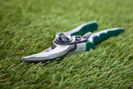 Close-up Of Pliers Gardening Tool On Green Grassの写真素材