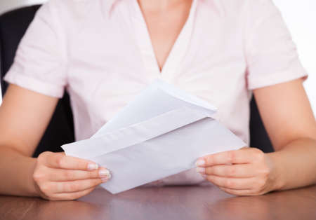 Closeup Of Young Businesswoman Holding Envelope With Letterの写真素材