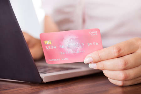 Close-up Of Female Hand With Credit Card Shopping Onlineの写真素材