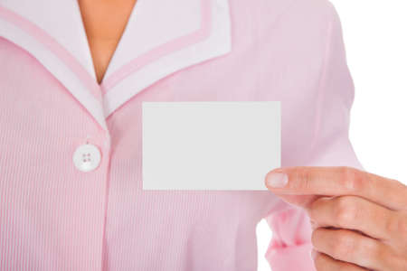 Young Female Maid Showing Visiting Card Over White Backgroundの写真素材