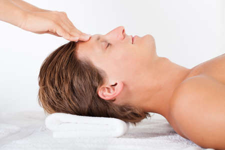 Portrait Of A Young Man Getting Head Massage In Spaの写真素材