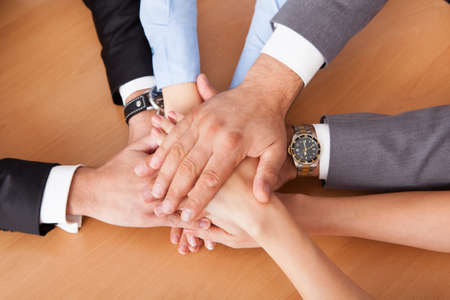 High Angle View Of Businesspeople Stacking Hands Over Each Other