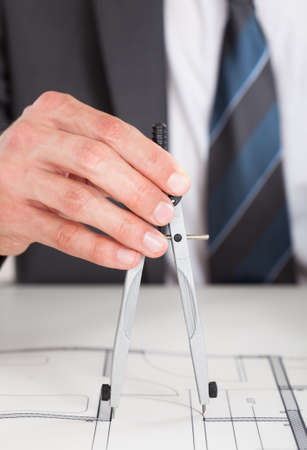 Close-up Of Person's Hand Drawing Plan On Blue Print