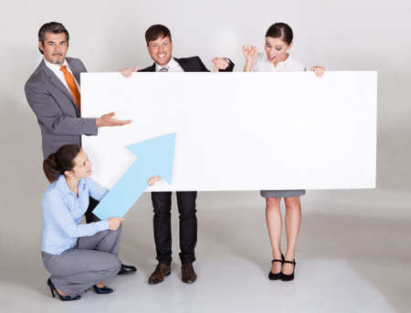 Group Of Businesspeople In A Row Holding Placardの写真素材