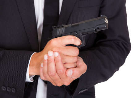 Close-up Of A Male Spy In Suit Holding Handgunの写真素材
