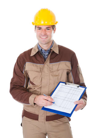 Portrait Of Young Mechanic Wearing Hardhat With Clipboardの写真素材