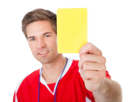 Portrait Of Male Soccer Referee Holding Yellow Card