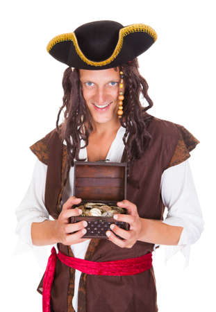 Happy Young Pirate Holding Treasure Box Over White Backgroundの写真素材