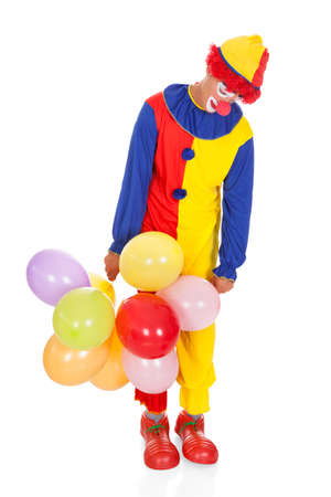 Portrait Of A Sad Clown With Multi Colored Balloons On White Backgroundの写真素材