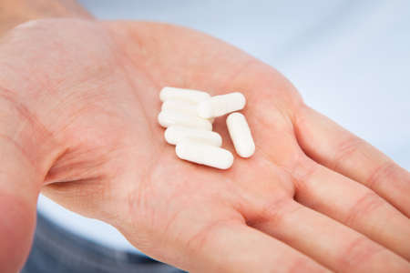 Capsule Held On Palm Of A Person