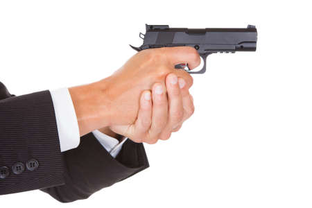 Close-up Of A Male Spy In Suit Holding Handgunの写真素材