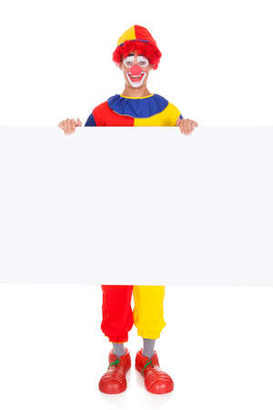 Portrait Of A Happy Joker Holding Blank Placard Over White Backgroundの写真素材