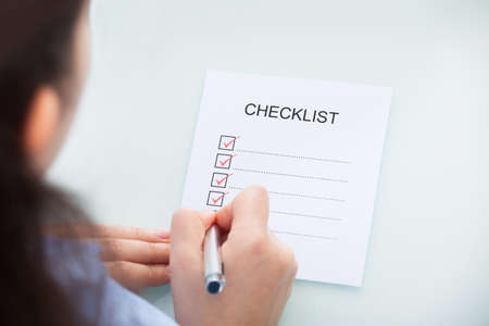High Angle View Of A Businesswoman Marking On Checklist At Deskの写真素材