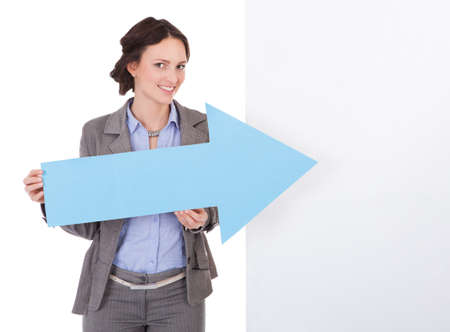 Portrait Of Happy Young Businesswoman Presenting Empty Placard