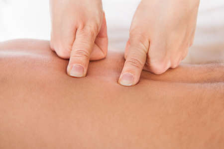 Close-up Of Person Receiving Shiatsu Treatment From Massager