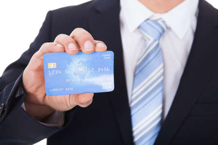 Close-up Of Young Businessman Holding Credit Cardの写真素材