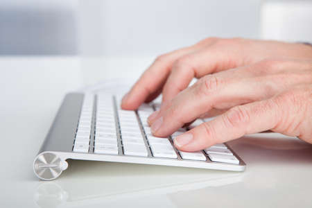 Close-up Of Person's Hand Typing On Keyword