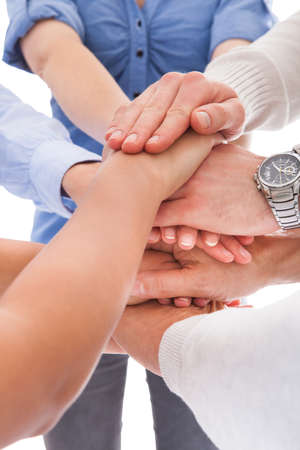 Close-up Of Many Hands Lying On Top Of Each Other