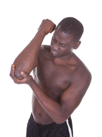 Portrait Of An African Young Man Suffering From Elbow Pain On White Backgroundの写真素材